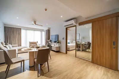 a living room with a dining table and a living room at Beachside 1 BR apartment by NLA in Bang Tao Beach