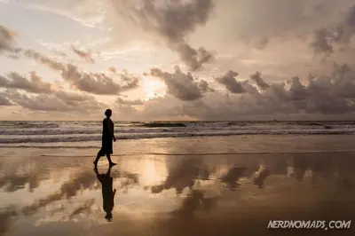 a man walking on the beach at sunset at Tropical Hideaway Close to the Beach in Ban Thalat Choeng Thale