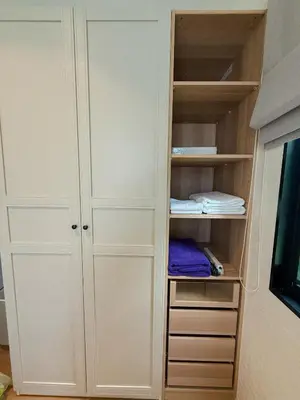 a closet with white cabinets and a tv at FAMILY HOMES - Brand New 2BDRM Poolside Apartment in Phuket