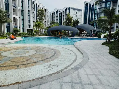 a swimming pool in a city with tall buildings at FAMILY HOMES - Brand New 2BDRM Poolside Apartment in Phuket