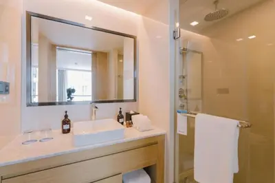 a bathroom with a sink and a mirror and a shower at Stylish studio on Rawai beach in Rawai Beach