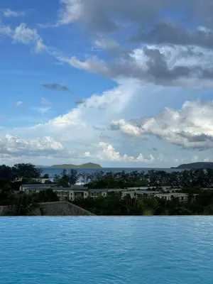 a large body of water with buildings in the background at Stylish studio on Rawai beach in Rawai Beach