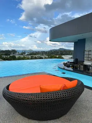a pool with a circular bed in front of a building at Stylish studio on Rawai beach in Rawai Beach