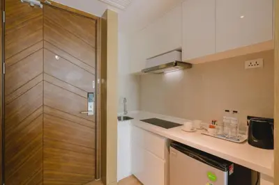 a small kitchen with a counter and a refrigerator at Stylish studio on Rawai beach in Rawai Beach