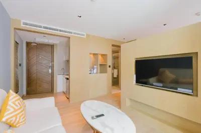 a living room with a large flat screen tv on a wall at Stylish studio on Rawai beach in Rawai Beach