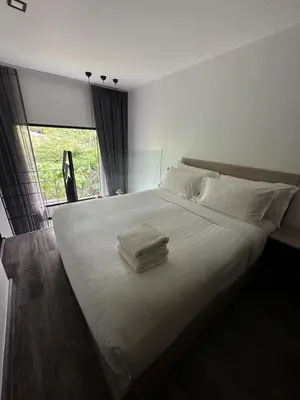 a large white bed with two towels on it at Modern apartment Utopia Naiharn (A22) in Rawai Beach