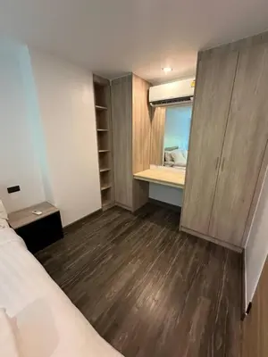 a small room with a bed and a mirror at Modern apartment Utopia Naiharn (A22) in Rawai Beach