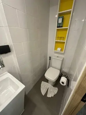 a bathroom with a white toilet and a sink at Modern apartment Utopia Naiharn (A22) in Rawai Beach