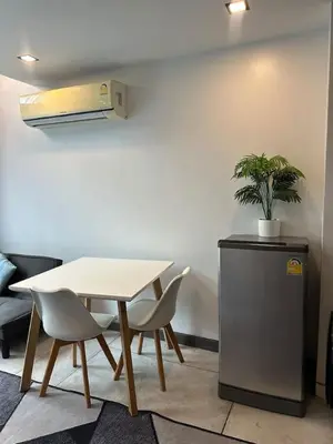 a table and chairs and a table and a plant at Modern apartment Utopia Naiharn (A22) in Rawai Beach