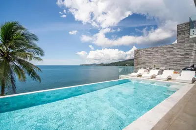 a swimming pool with a view of the ocean at Kamala Beach Front Sea View 6 Bedroom Villa in Kamala Beach