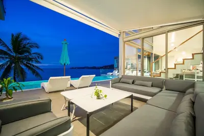 a living room with a couch and a table at Kamala Beach Front Sea View 6 Bedroom Villa in Kamala Beach