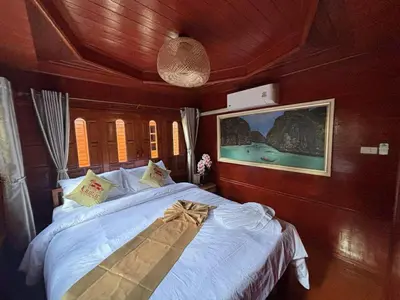a bedroom with a bed on a boat at Guitar Thai Style Pool House in Ao Nang Beach