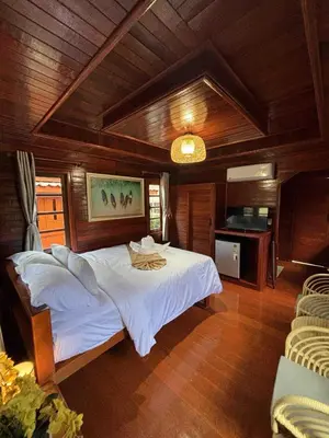 a bedroom with a large white bed in a room at Guitar Thai Style Pool House in Ao Nang Beach