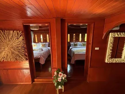 a bedroom with two mirrors and two beds at Guitar Thai Style Pool House in Ao Nang Beach