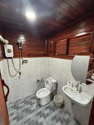 a bathroom with a toilet and a sink at Guitar Thai Style Pool House in Ao Nang Beach