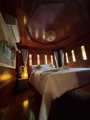 a bedroom with a large bed in a boat at Guitar Thai Style Pool House in Ao Nang Beach