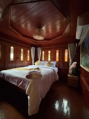 a bedroom with a large bed with a wooden ceiling at Guitar Thai Style Pool House in Ao Nang Beach