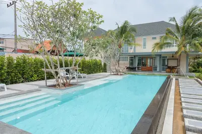 a swimming pool in front of a house at Fisherman Way Beach Villa in Rawai Beach