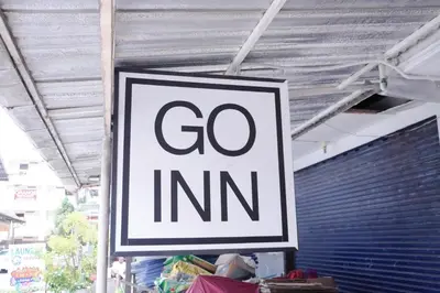 a sign that says go inn hanging from a ceiling at xx GO INN Patong Beach Phuket - โกอินน์ ป่าตอง in Patong Beach