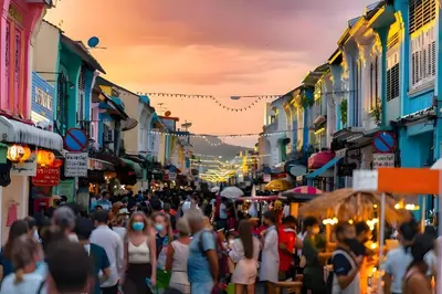 a crowd of people walking down a crowded city street at xx GO INN Patong Beach Phuket - โกอินน์ ป่าตอง in Patong Beach