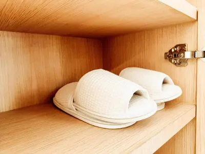 two white hats sitting on a wooden shelf at Laksika Place Khao Rang in Phuket Town