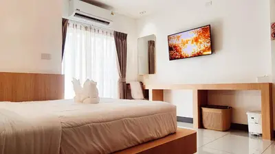 a bedroom with a bed with a stuffed animal on it at Laksika Place Khao Rang in Phuket Town