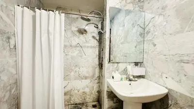 a bathroom with a sink and a shower curtain at Cozy condo maikhao Phuket in Ban Mai Salae