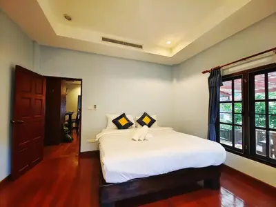 a bedroom with a large white bed and a window at Secure 3 Bedroom Villa near beach in Kamala Beach