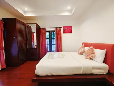 two cats sitting on a bed in a bedroom at Secure 3 Bedroom Villa near beach in Kamala Beach