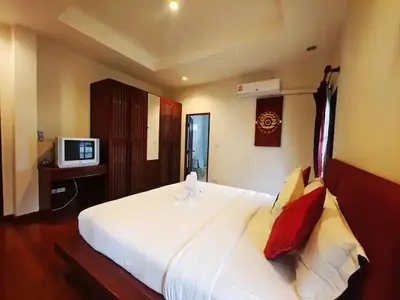 a bedroom with a large white bed and a television at Secure 3 Bedroom Villa near beach in Kamala Beach