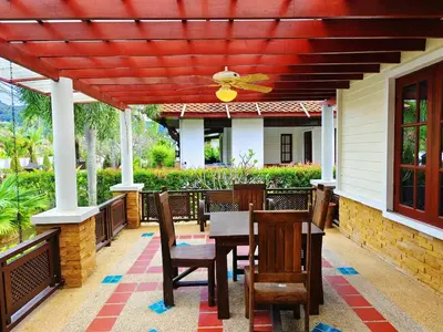 a patio with a table and chairs and a ceiling at Secure 3 Bedroom Villa near beach in Kamala Beach