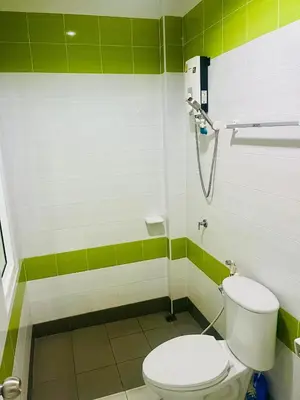 a bathroom with a toilet and a shower at Ann & John Guesthouse in Patong Beach
