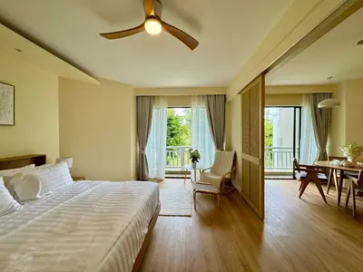 a bedroom with a bed and a ceiling fan at Cozy 1 BR Allamanda Laguna Phuket in Laguna Phuket