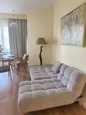 a living room with a large couch in a room at Cozy 1 BR Allamanda Laguna Phuket in Laguna Phuket