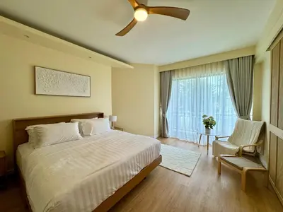 a bedroom with a bed and a ceiling fan at Cozy 1 BR Allamanda Laguna Phuket in Laguna Phuket