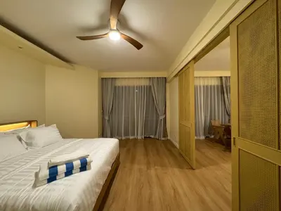 a bedroom with a bed and a ceiling fan at Cozy 1 BR Allamanda Laguna Phuket in Laguna Phuket