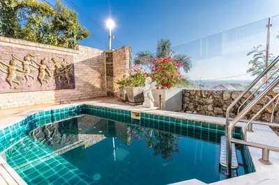 a swimming pool in the middle of a house at Tropical 2BR Villa Sunset & Sea View in Karon Beach