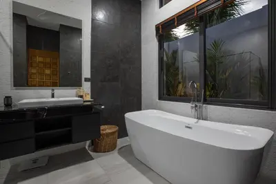 a bathroom with a large white tub and a sink at Andaman Paradise 2 Luxury 4 Bedrooms Pool Villa in Rawai Beach