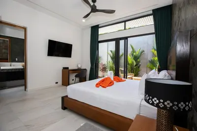 a bedroom with a bed and a large window at Andaman Paradise 2 Luxury 4 Bedrooms Pool Villa in Rawai Beach