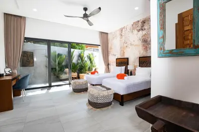 a hotel room with two beds and a desk at Andaman Paradise 2 Luxury 4 Bedrooms Pool Villa in Rawai Beach