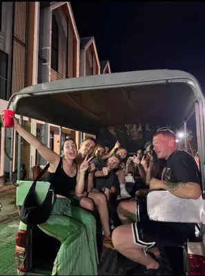 a group of people sitting in the back of a bus at Global Beach Hostel - Ao Nang in Ban Khlong Haeng