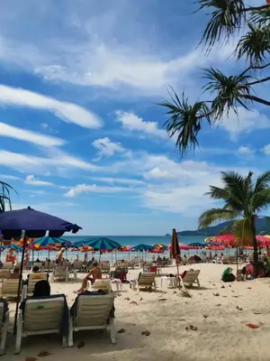 a beach with chairs and umbrellas and the ocean at \u9876\u7ea7\u9ad8\u5c14\u592b\u7403\u573a\u98ce\u666f in Phuket