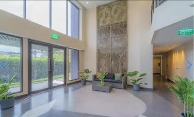 a lobby with potted plants in a building at \u9876\u7ea7\u9ad8\u5c14\u592b\u7403\u573a\u98ce\u666f in Phuket