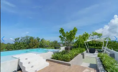 a swimming pool with a deck and stairs next to at \u9876\u7ea7\u9ad8\u5c14\u592b\u7403\u573a\u98ce\u666f in Phuket