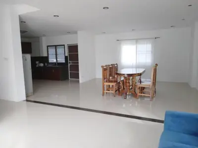 a dining room and kitchen with a table and chairs at Hillside 3 Bedroom Vacation Home with Pool in Kamala Beach