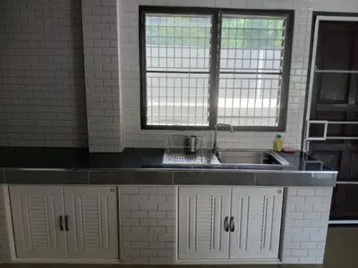 a kitchen with a sink and a window at Hillside 3 Bedroom Vacation Home with Pool in Kamala Beach