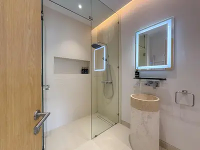a bathroom with a shower and a glass door at Sumptuous Duplex Pool Villa 3BR in Newly Built LuxPride 4 L12 Residence in Bang Tao Beach