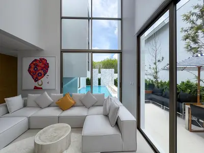 a living room with a white couch and a pool at Sumptuous Duplex Pool Villa 3BR in Newly Built LuxPride 4 L12 Residence in Bang Tao Beach