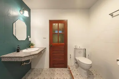 a bathroom with a toilet and a sink at Areca Holiday Home 8, Bangtao Beach in Ban Thalat Choeng Thale