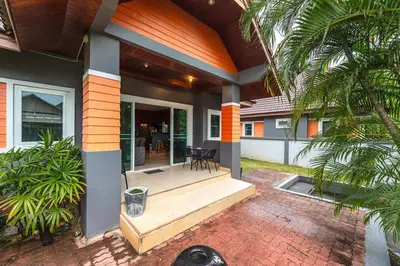a house with a porch with a patio at Areca Holiday Home 8, Bangtao Beach in Ban Thalat Choeng Thale
